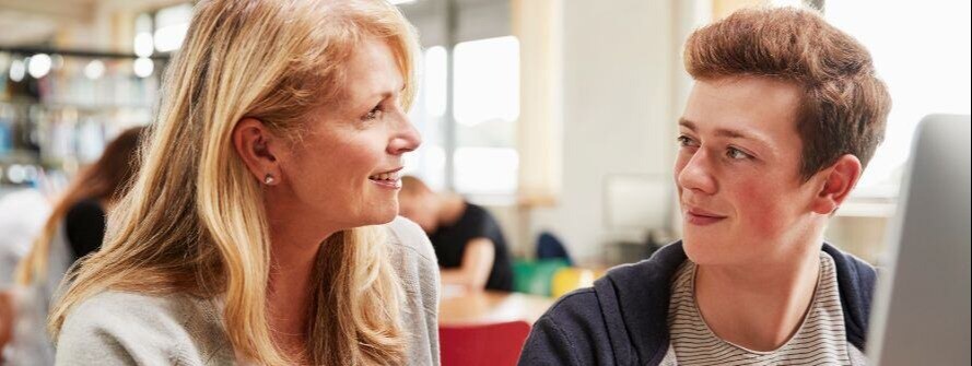 Teacher and college student chatting