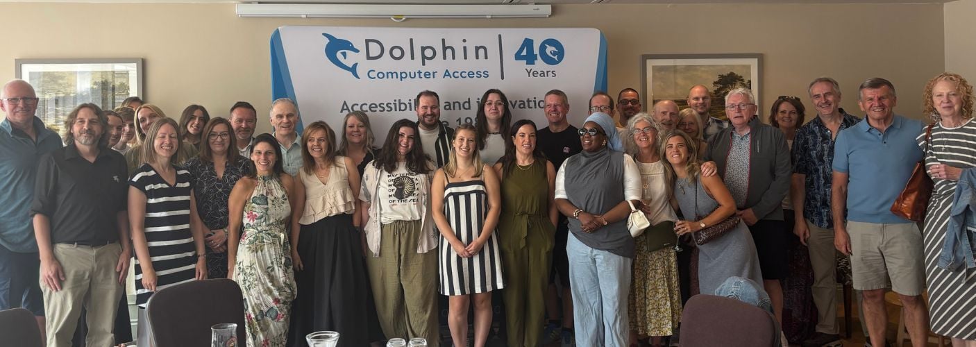 Dolphin team standing in front of a Dolphin at 40 years banner