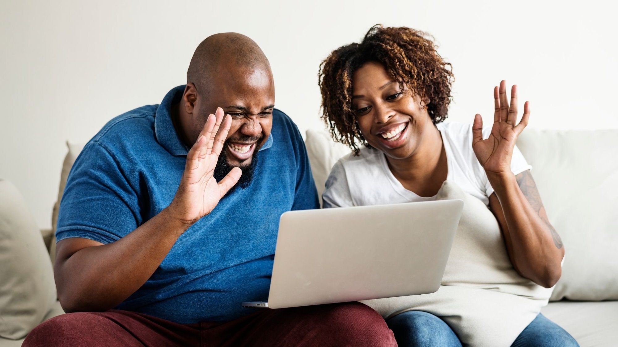 Couple waving towards screen on video call