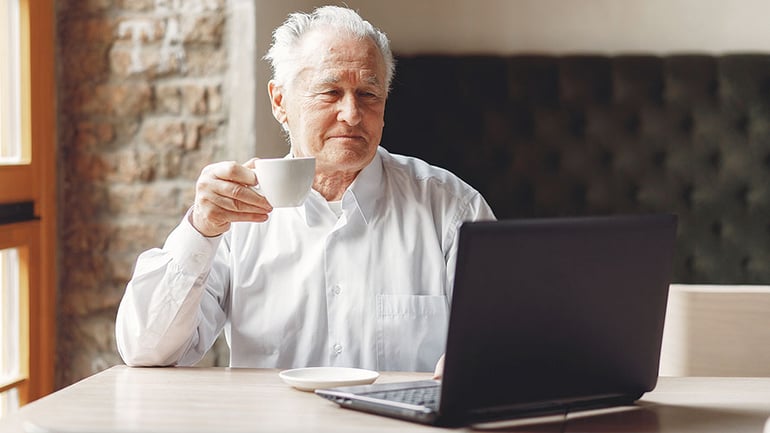 Man with laptop and a cup of tea