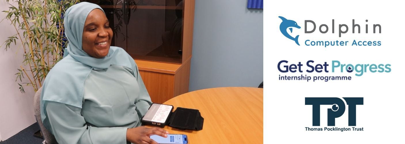 Laura smiles in the office. her phone and braille note taker are on the desk in front of her.  The Dolphin, Get Set Progress and TPT logos are shown on the right.