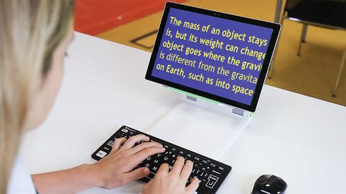 Student sat at a desk using the SuperNova Connect & Learn kit.