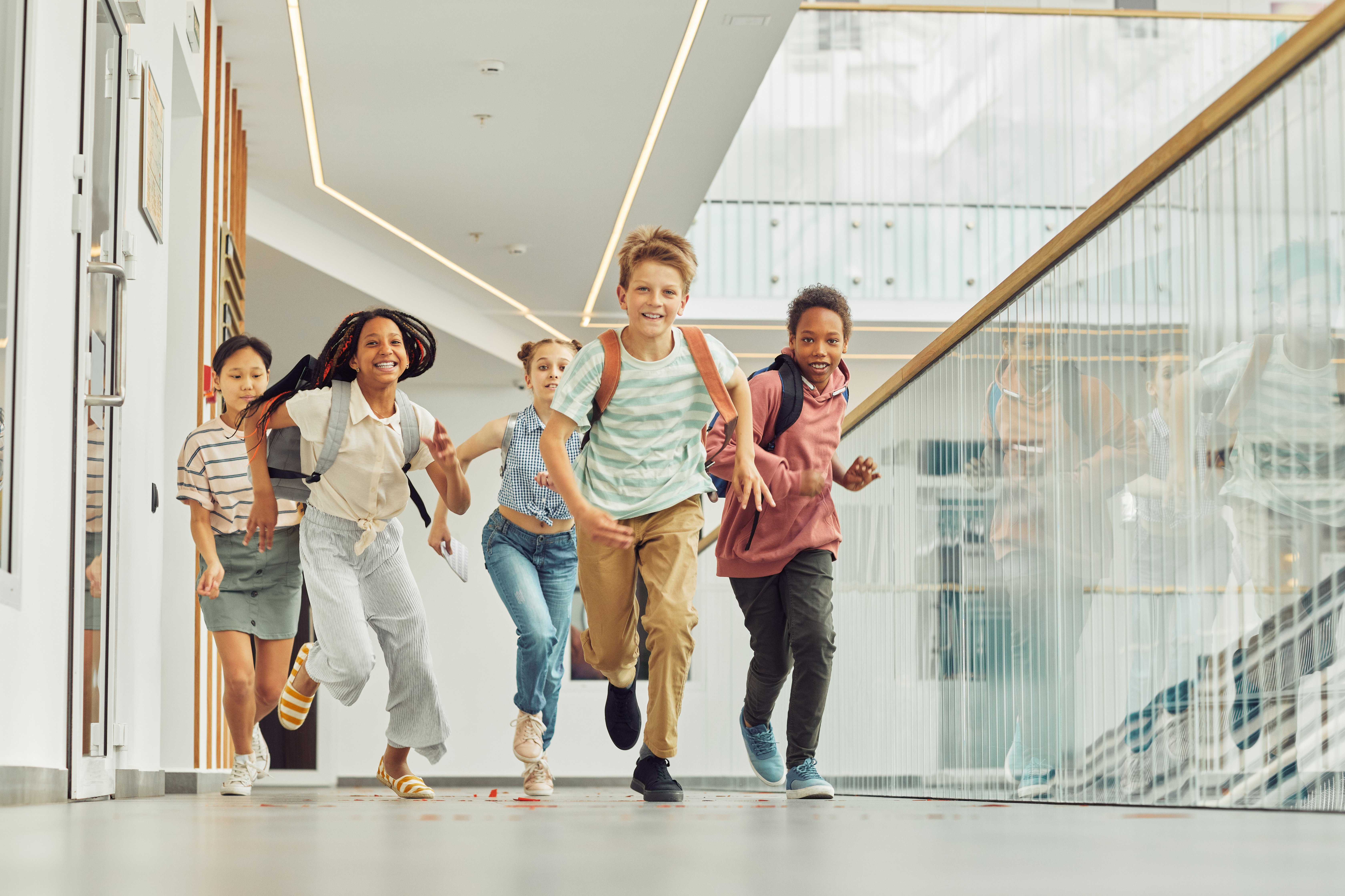 group of children running in a corridor